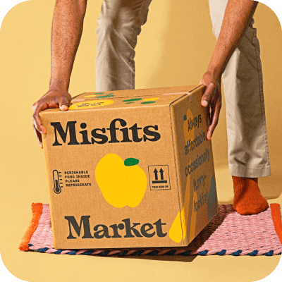 Person picking up a Misfits Market box