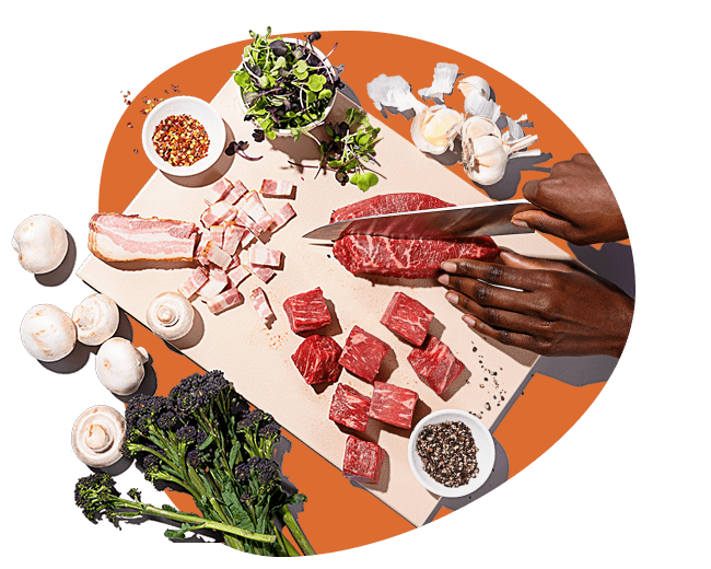 Image of person slicing an assortment of meat on a cutting board