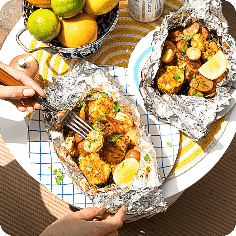 Image of person's hands eating fish with lemon