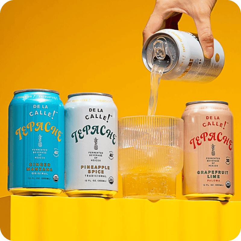 Hand pouring Tepache beverage into a glass