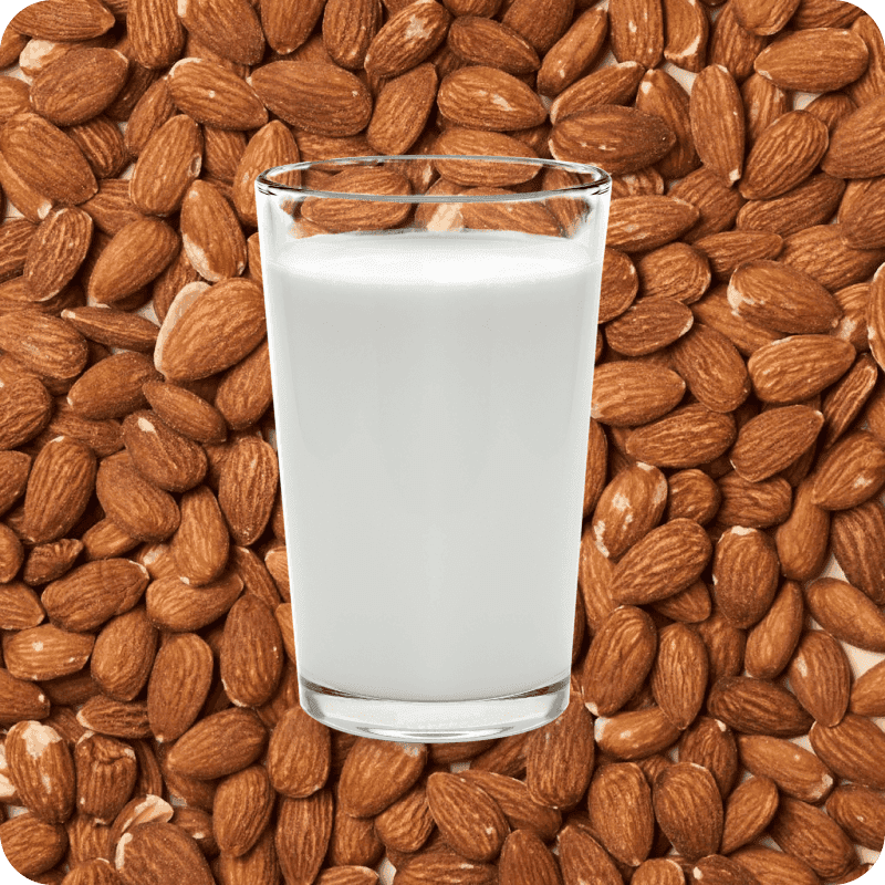 Glass of milk on a background of almonds