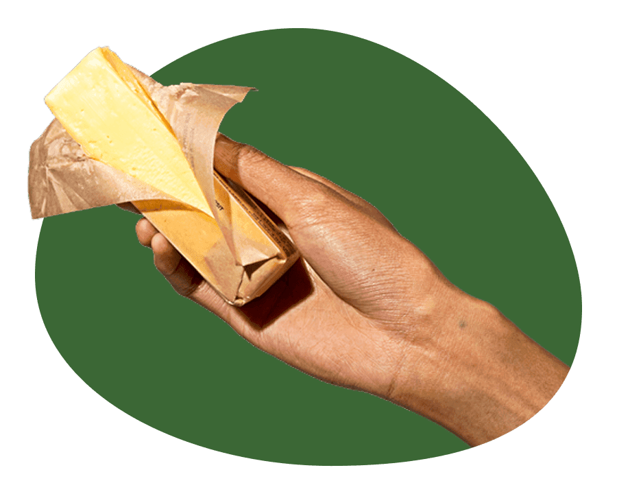 Hands holding a block of Grade AA butter, highlighting the quality of Misfits Market butter delivery