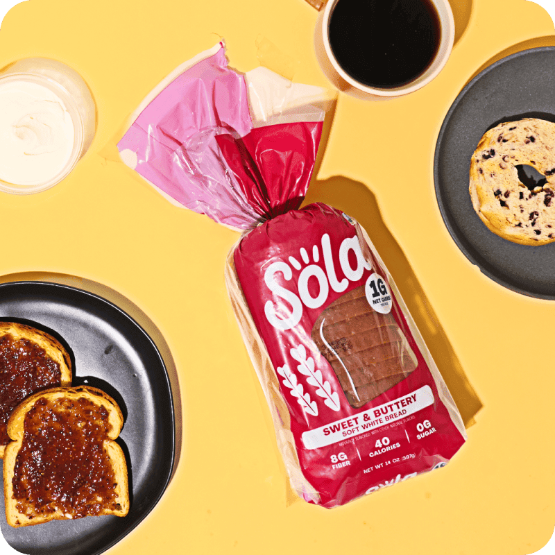 Sola brand high-protein sandwich bread with plates and food in the background, available through Misfits Market bread delivery