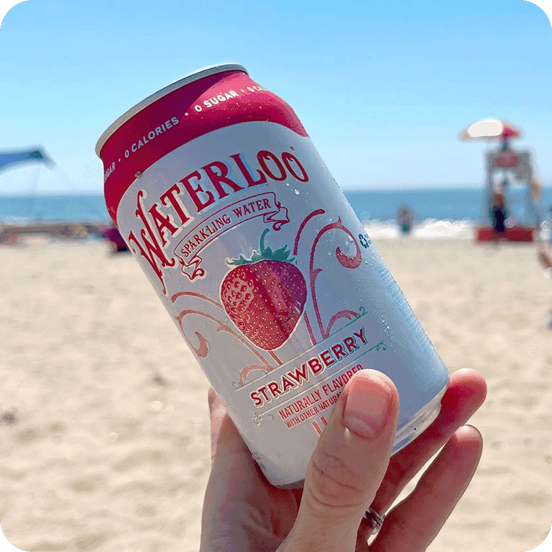 Hand holding a can of Waterloo sparkling water