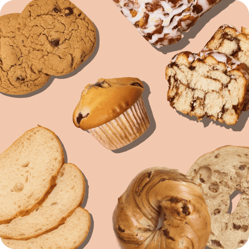 Assorted baked goods including cookies, muffin, croissant, and bread slices available for delivery
