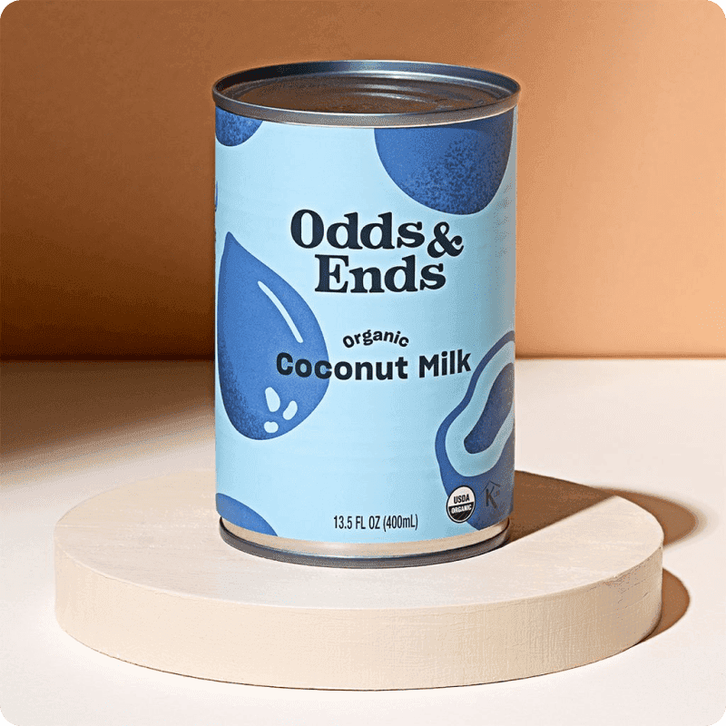 Odds & Ends USDA organic canned coconut milk, 13.5 fl oz, a canned goods delivery staple displayed on a minimal white pedestal.