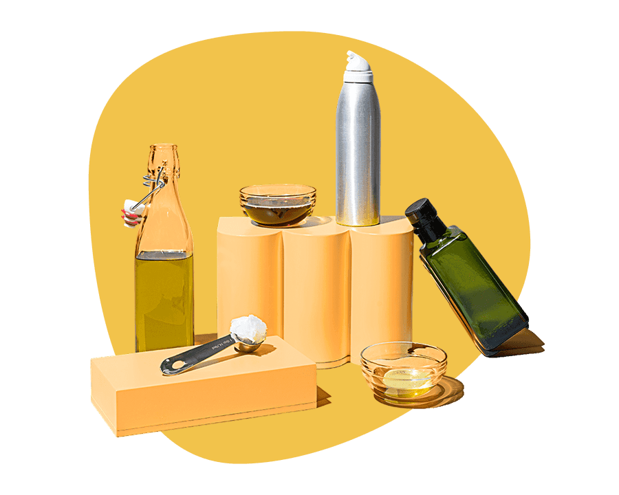 Assortment of cooking oils including olive oil and coconut oil displayed on yellow pedestals, shop cooking oil delivery from Misfits Market.