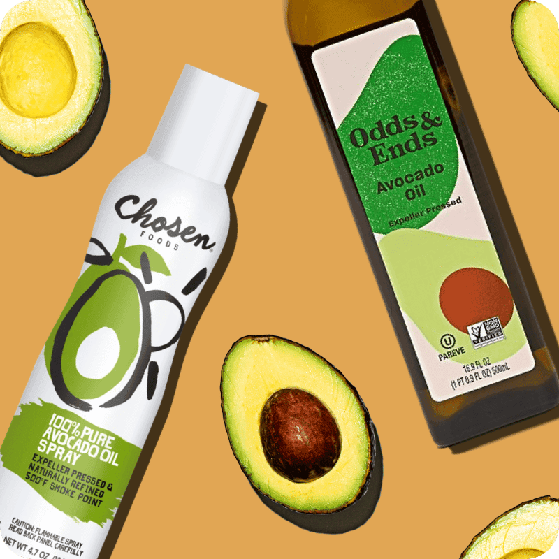 Chosen Foods Avocado Oil Spray and Odds & Ends Expeller Pressed Avocado Oil bottles surrounded by fresh avocados, shop avocado oil delivery from Misfits Market.