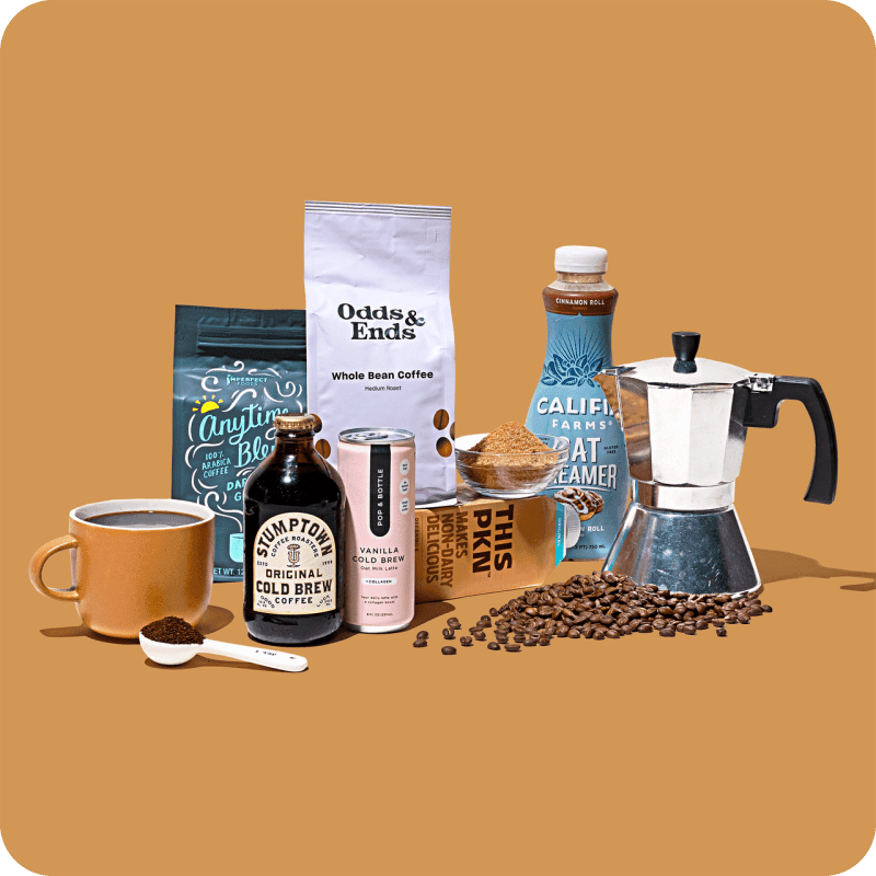 Order coffee beans online: Odds & Ends whole bean coffee bag alongside cold brew bottles, oat creamer, and a moka pot.